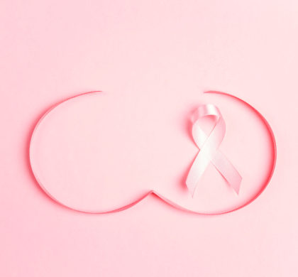 Pink ribbon with breast shape symbol on pink background. Breast cancer awareness symbol. October awareness month campaign.