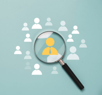 Magnifier glass focus to manager icon which is among staff icons for human development recruitment leadership and customer target group concept.