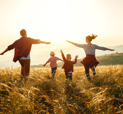 Happy family: mother, father, children son and  daughter on nature  on sunset